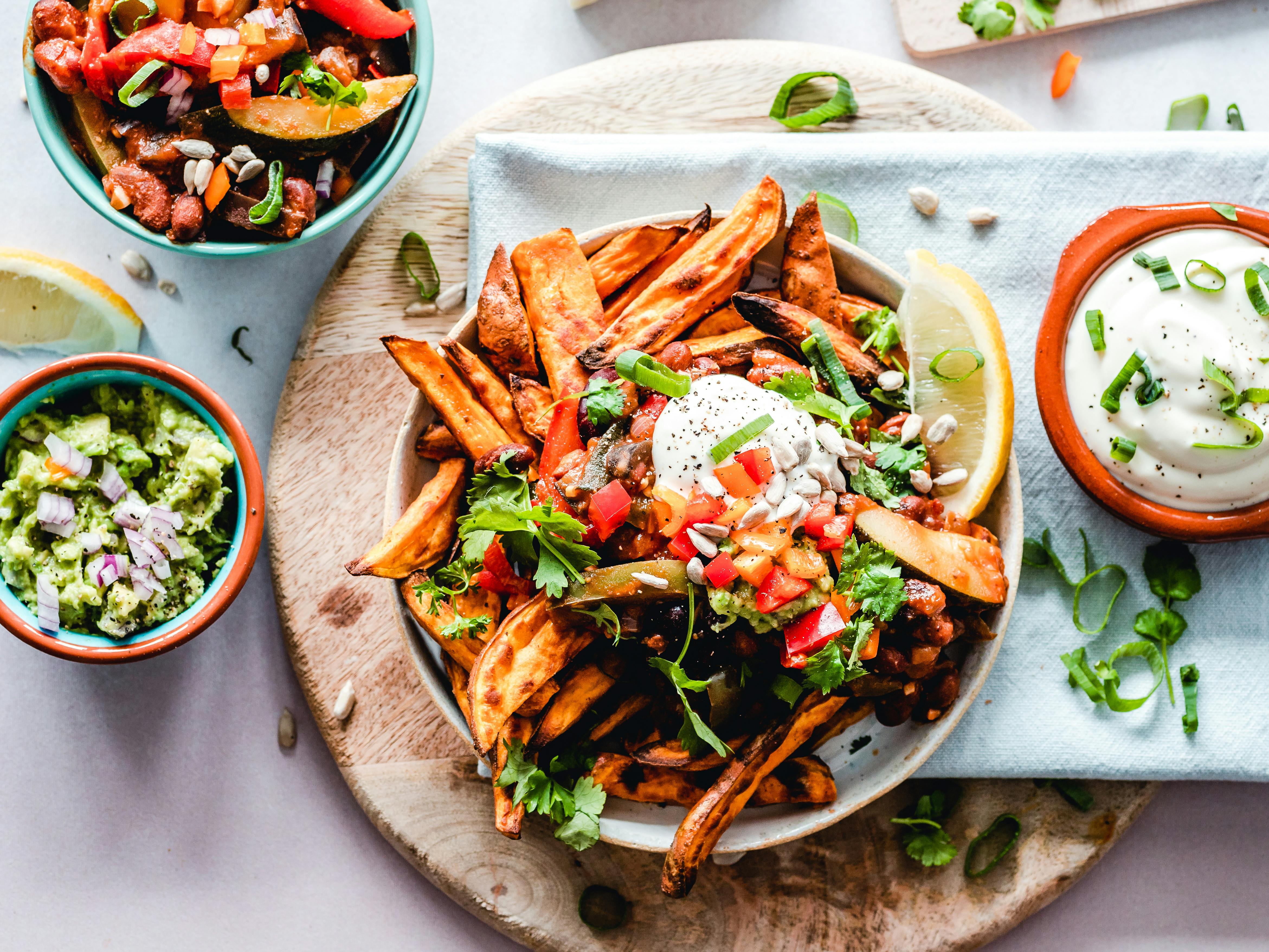 Delicious food platter with sweet potato fries and dips